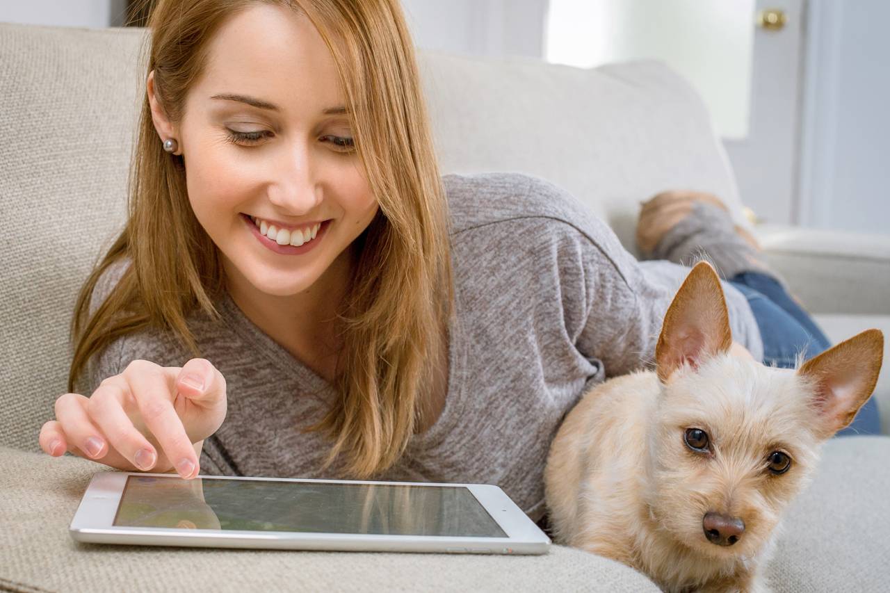 Girl holding dog using ipad - Optometrist - Hickman, NE